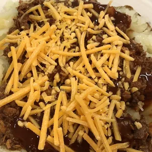 Assembling my Chopped Beef Baked Potato. Lots of cheese !!!