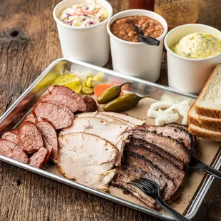 a platter of meat and sides