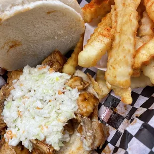 Chicken sandwich in BBQ sauce with French fries