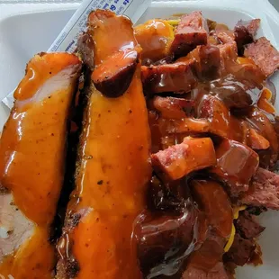 Ribs, sausage, and brisket loaded potato