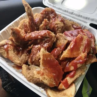 a tray of chicken wings with ketchup