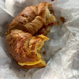 half eaten Bacon and Egg Sandwich (on a croissant)