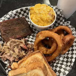 Three meats with onion rings and Mac and cheese
