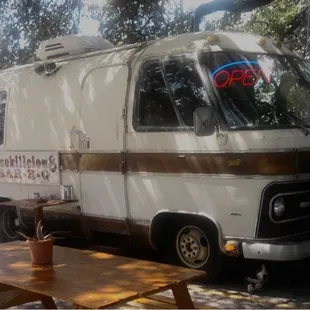 ows a white van parked in a parking lot