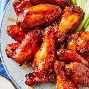 a plate of wings and celery