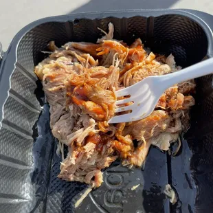  fork sticking out of a plastic container