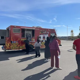  group of people standing in front of a food truck