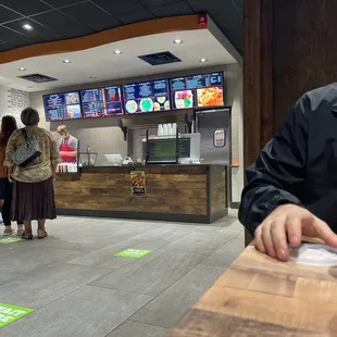 a man sitting at a table in a fast food restaurant