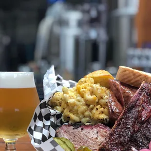 a plate of food and a glass of beer