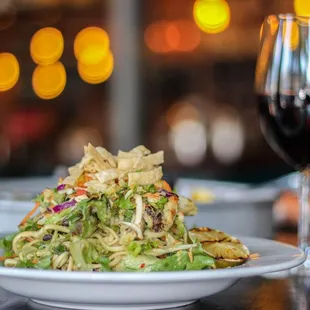 a plate of food and a glass of wine