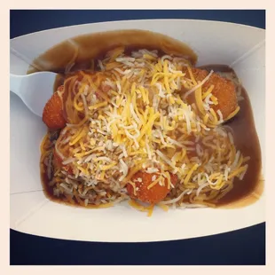 Fried mash potato balls poutine-style w brown gravy, cheese
