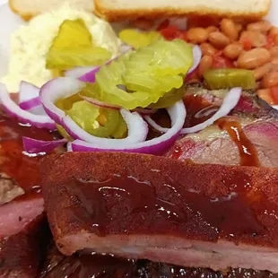 Boari Sausage, prime brisket, pork ribs, potato salad, beans and sourdough bread with all the trimmings.