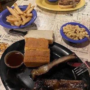  plate of ribs, french fries and a sandwich