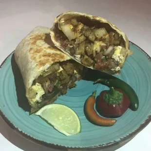 Breakfast burrito with potato, bacon, cheese, beans and egg.