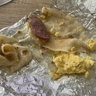 ows a sausage, scrambled eggs, and quesadilla