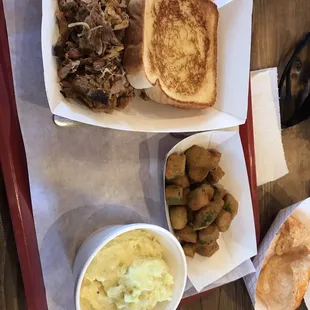 Pulled pork with Texas toast and two sides. Fried okra and potato salad