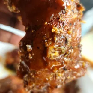  hand holding a piece of meat