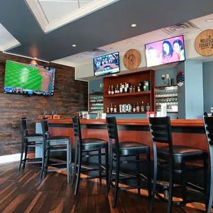  bar with a television and bar stools