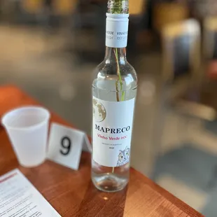 a bottle of naprreco with a flower in it