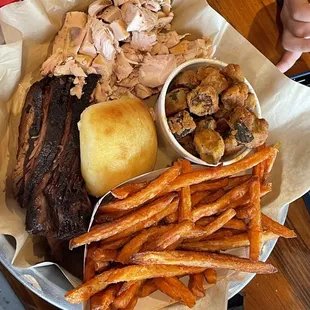 Chicken and Brisket plate with okra sweet potato fries and a roll.