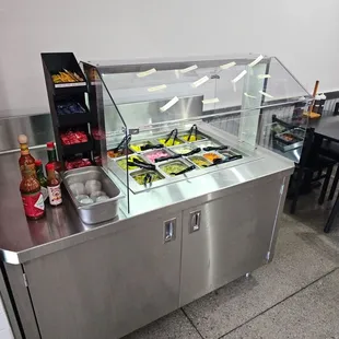 Condiment bar!  Limes, jalapeños. pepperchini, peppers, sauces, onions, bottle sauces, package sauces.