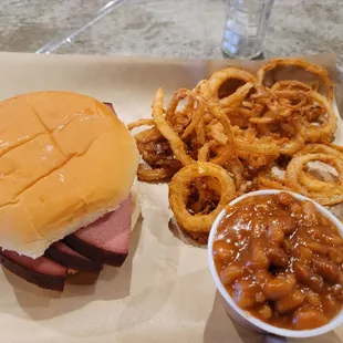 Bologna sandwich with onion rings and beans
