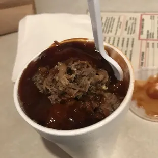 a cup of soup and a spoon
