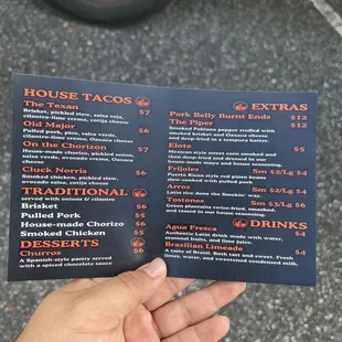 a hand holding a menu