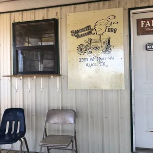 two chairs and a sign