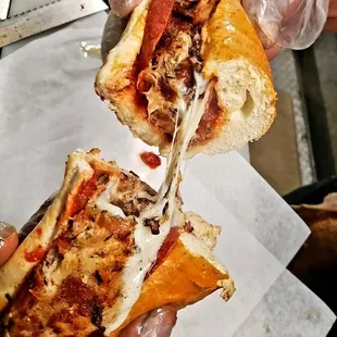 a hand holding a sandwich