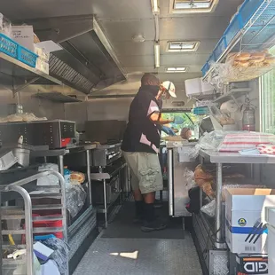 a man preparing food in a food truck