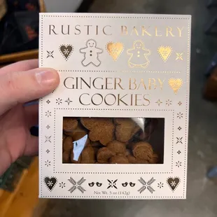 a person holding up a box of cookies