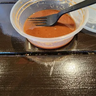a fork in a bowl of bbq sauce