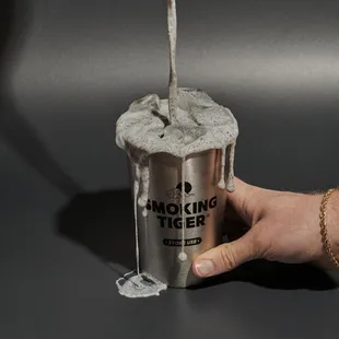 a hand holding a cup of coffee