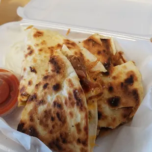 Chicken quesadilla! Has rice, chicken, Cheese, black beans and corn inside flour tortilla