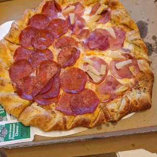 Half and half pizza, pepperoni and Canadian bacon. Generous with the toppings.
