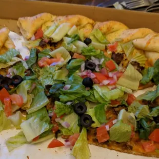 Half of a taco pizza. Forgot to take a picture first. It's loaded.