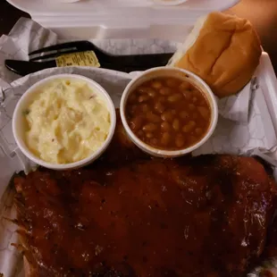 Half rack of ribs with baked beans, bun and potato salad