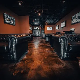 eather couches in a dimly lit room