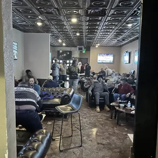 eople sitting at tables in a restaurant