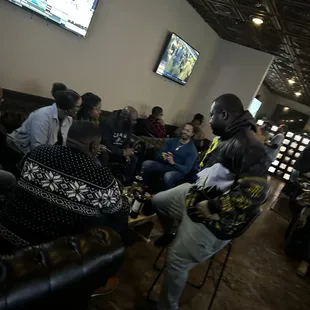  group of people sitting in a lounge