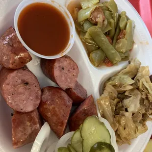 Sausage plate with cabbage and green beans.