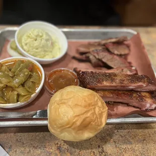 Two meat plate with potato salad, green beans, ribs, and brisket.