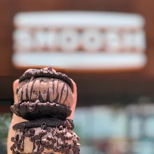 a hand holding a stack of cookies