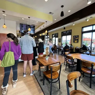 people walking through a coffee shop