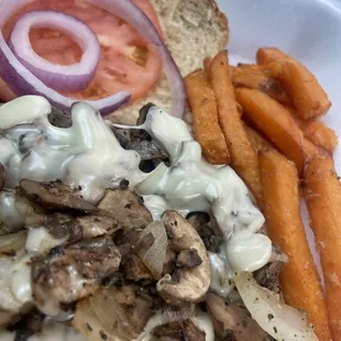 Mushroom burger with vegan cheese and sweet potato fries ..