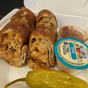 a sandwich and a pickle on a styrofoam container