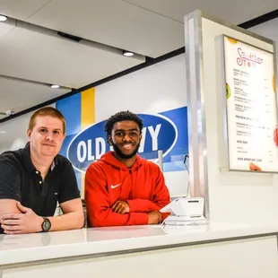 two men sitting at a counter