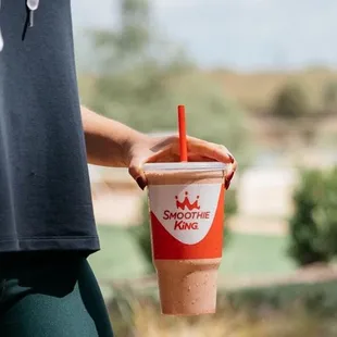 a person holding a cup of coffee