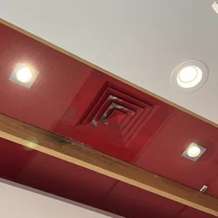 a red ceiling with recessed lights